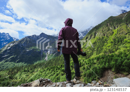 Woman photographer with camera in summer high altitude mountains, China 123148537