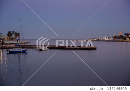 Tranquil Harbor Scene with Boats at Twilight evining time calm sea Tranquil Harbor Scene with Boats at Twilight evining time calm sea 123149806