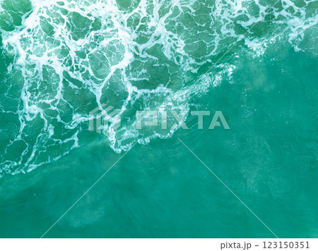 Overhead view turquoise stormy ocean waves with white foam in the ocean,Sea water with splashes and foam, Top view waves background, Natural background photo sea texture with waves soft focus Overhead view turquoise stormy ocean waves with white foam in the ocean,Sea water with splashes and foam, Top view waves background, Natural background photo sea texture with waves soft focus 123150351