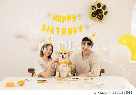 A young couple preparing for their dog's birthday party A young couple preparing for their dog's birthday party 123152841