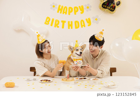 A young couple preparing for their dog's birthday party A young couple preparing for their dog's birthday party 123152845