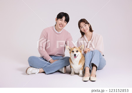 Family photo of a young couple raising a cute Welsh Corgi Family photo of a young couple raising a cute Welsh Corgi 123152853