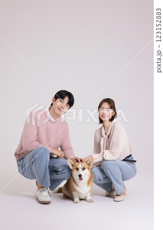 Family photo of a young couple raising a cute Welsh Corgi 123152883