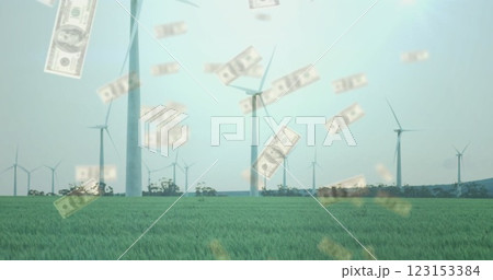 Wind turbines in green field with falling money image 123153384