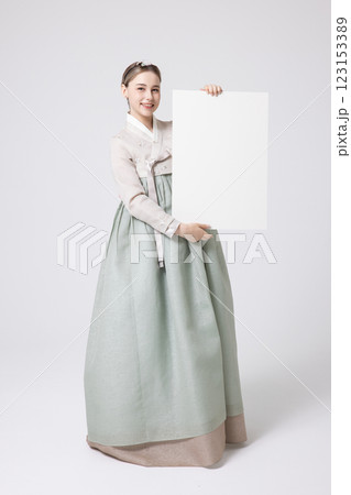 Portrait of a Western woman wearing Hanbok and standing with copyspace Portrait of a Western woman wearing Hanbok and standing with copyspace 123153389