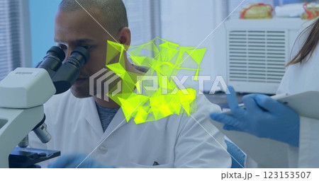 Image of glowing light trails over diverse scientists in laboratory 123153507