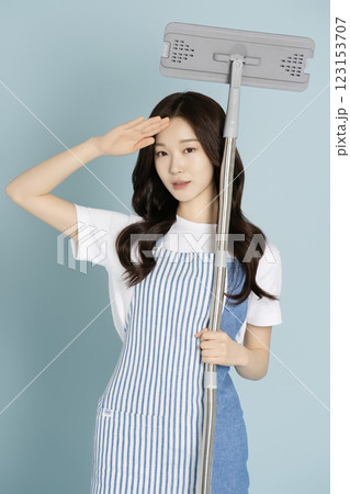 A woman in her 20s holding a gunny mop A woman in her 20s holding a gunny mop 123153707