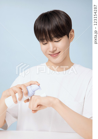 A young man demonstrating basic men's cosmetics 123154287