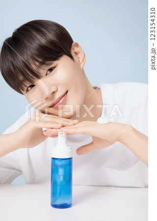 A young man demonstrating basic men's cosmetics 123154310