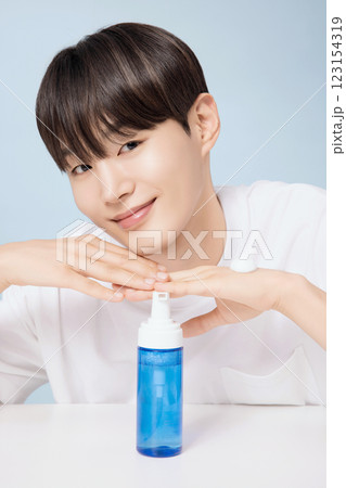 A young man demonstrating basic men's cosmetics A young man demonstrating basic men's cosmetics 123154319