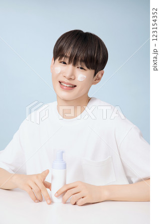 A young man demonstrating basic men's cosmetics 123154352