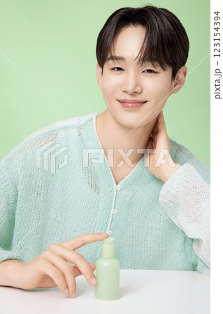 A man in his 20s posing with green essence A man in his 20s posing with green essence 123154394