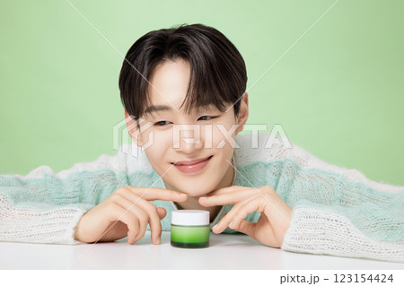 A man in his 20s posing with green essence 123154424