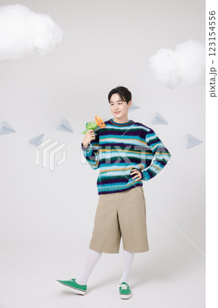 Cropped view of man standing in clouds holding toy bubble gun 123154556