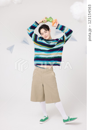 Cropped view of man standing in clouds holding toy bubble gun 123154563