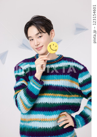 Portrait of a man standing in the clouds holding candy Portrait of a man standing in the clouds holding candy 123154601