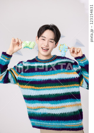 Portrait of a man standing in the clouds holding candy 123154631