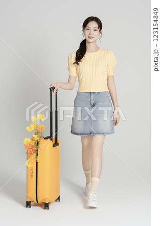 A woman in her 20s traveling with a suitcase A woman in her 20s traveling with a suitcase 123154849