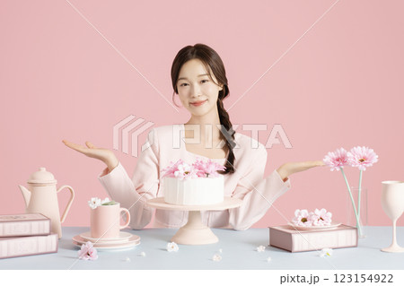 A woman in her 20s sitting in front of a cake A woman in her 20s sitting in front of a cake 123154922