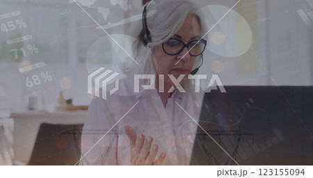 Image of financial data processing over senior caucasian woman using phone headset and laptop 123155094