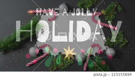 Have jolly holiday text image over Christmas decorations with candy canes and pine branches 123155694