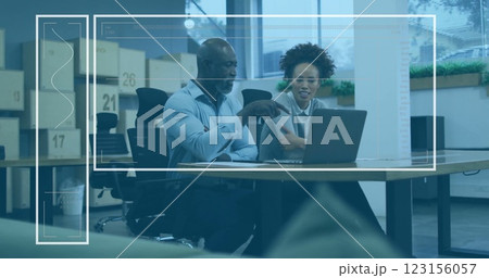 Discussing project at desk, colleagues with laptop over data processing image 123156057