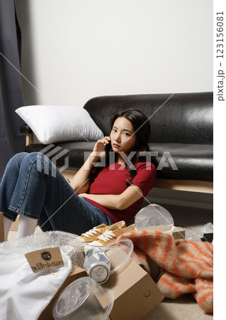 A young man in his 20s suffering from burnout, helpless in a messy room A young man in his 20s suffering from burnout, helpless in a messy room 123156081