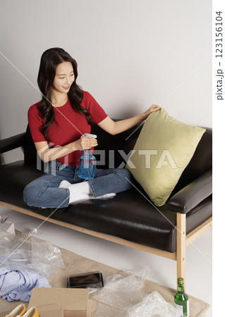 A young man in his 20s cleaning his room A young man in his 20s cleaning his room 123156104
