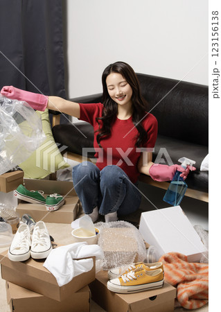 A young man in his 20s cleaning his room wearing rubber gloves 123156138