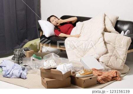A young man in his 20s suffering from burnout, helpless in a messy room A young man in his 20s suffering from burnout, helpless in a messy room 123156139