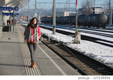woman listen the phone on the platform of salzburg, austria when she wait for train woman listen the phone on the platform of salzburg, austria when she wait for train 123156956
