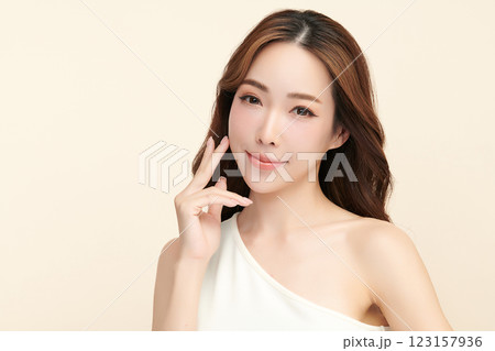 Beautiful young asian woman with clean fresh skin on beige background, Face care, Facial treatment, Cosmetology, beauty and spa, Asian women portrait. 123157936