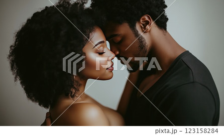 Romantic couple in a tender embrace, eyes closed, expressing deep love and connection in a soft 123158284