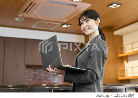 飲食店でパソコンを見るスーツを着た女性 123158884