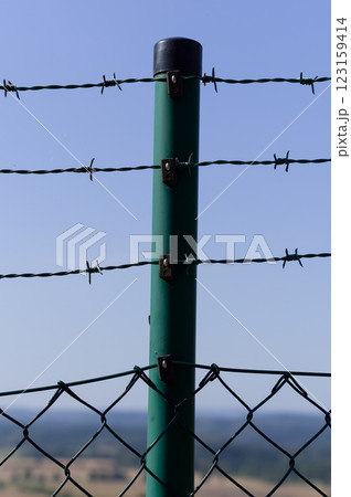 Close-up view of fencing that is made of steel wire. A device that prevents the entry of strangers and animals. Close-up view of fencing that is made of steel wire. A device that prevents the entry of strangers and animals. 123159414