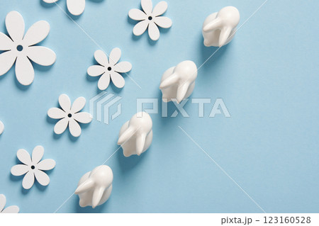 Minimalist Easter composition with white bunnies and flowers on a blue background. Space for your text. Minimalist Easter composition with white bunnies and flowers on a blue background. Space for your text. 123160528