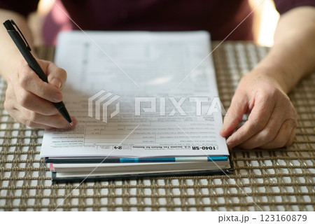 Senior Woman Filling Out Tax Form 123160879