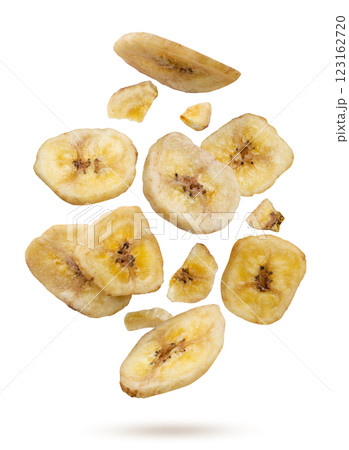 Dried banana chips and pieces flying on a white background. Isolated 123162720