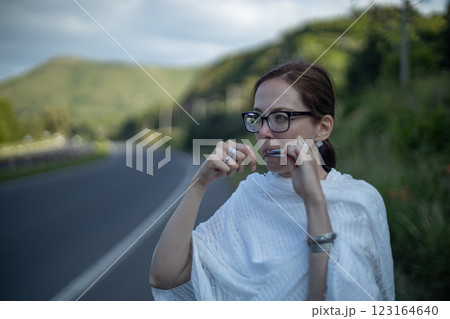 Playing harmonica while enjoying a serene countryside view on a sunny afternoon 123164640