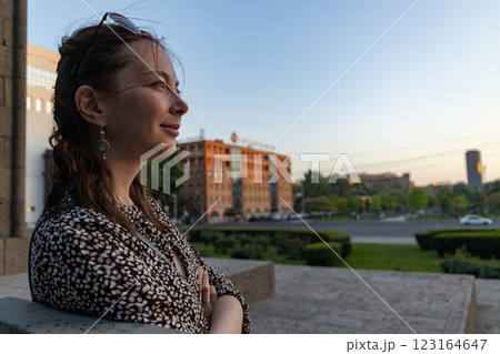 Contemplative moment as dusk settles over the cityscape with a woman lost in thought 123164647