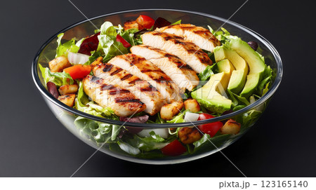 Delicious grilled chicken salad with fresh avocado and colorful vegetables in glass bowl. Concept of healthy eating, fresh ingredients, balanced diet, nutritious meals, meat 123165140