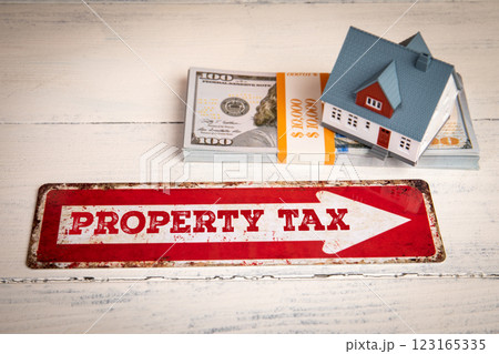 Property Tax. Red direction arrow sign on a white wooden table Property Tax. Red direction arrow sign on a white wooden table 123165335