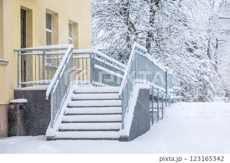 Icy and snow-covered entrance stairs. Metal structure Icy and snow-covered entrance stairs. Metal structure 123165342