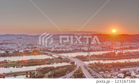 Aerial panoramic view of sunset over Vienna city with skyscrapers, historic buildings and a riverside promenade timelapse in Austria. Aerial panoramic view of sunset over Vienna city with skyscrapers, historic buildings and a riverside promenade timelapse in Austria. 123167166