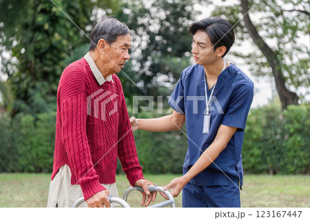 Elderly man receiving compassionate guidance from healthcare professional with a walker outdoors Elderly man receiving compassionate guidance from healthcare professional with a walker outdoors 123167447