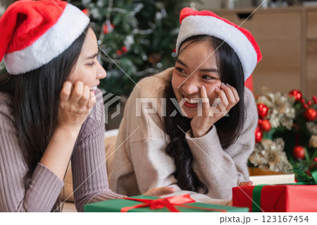 Joyful Lesbian Couple Celebrating Christmas Together with Gifts and Festive Decorations in Cozy Home Setting 123167454