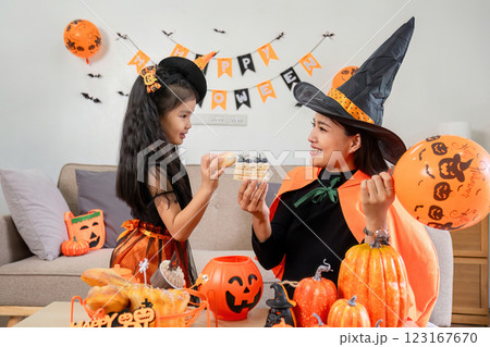 Mother and Child Enjoy Halloween Activities Together in Matching Costumes with Festive Decorations and Treats Mother and Child Enjoy Halloween Activities Together in Matching Costumes with Festive Decorations and Treats 123167670