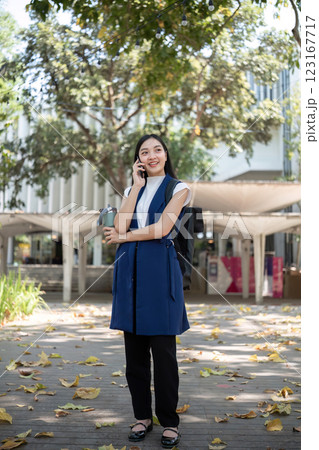 Confident Businessman Engaged in a Phone Conversation Outdoors in a Modern Urban Setting 123167717
