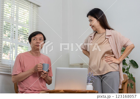 Diverse couple interacting playfully in a modern home office setting. 123168057