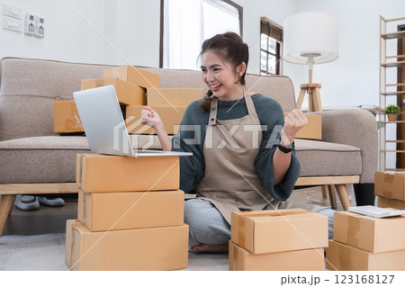 Small business owner celebrates success with successful online shopping business Small business owner celebrates success with successful online shopping business 123168127